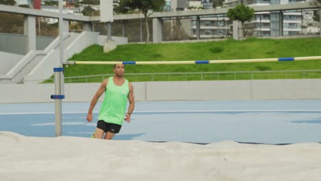 front view of caucasian athlete doing high jump