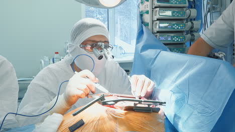 doctor works with laser scalpel in surgery room. surgeon with optical tools conducts artery bypass surgery in hospital. heart illness treatment