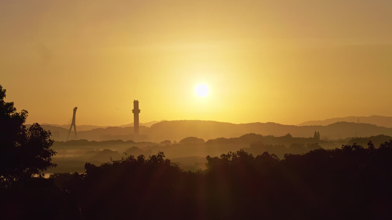 Sunset over misty hills and skyline at Guandu Nature Park in Taipei, Taiwan