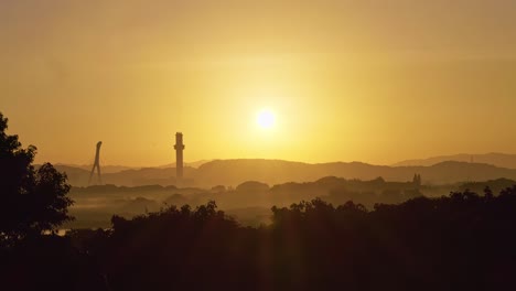 sunset over misty hills and skyline at guandu nature park in taipei, taiwan