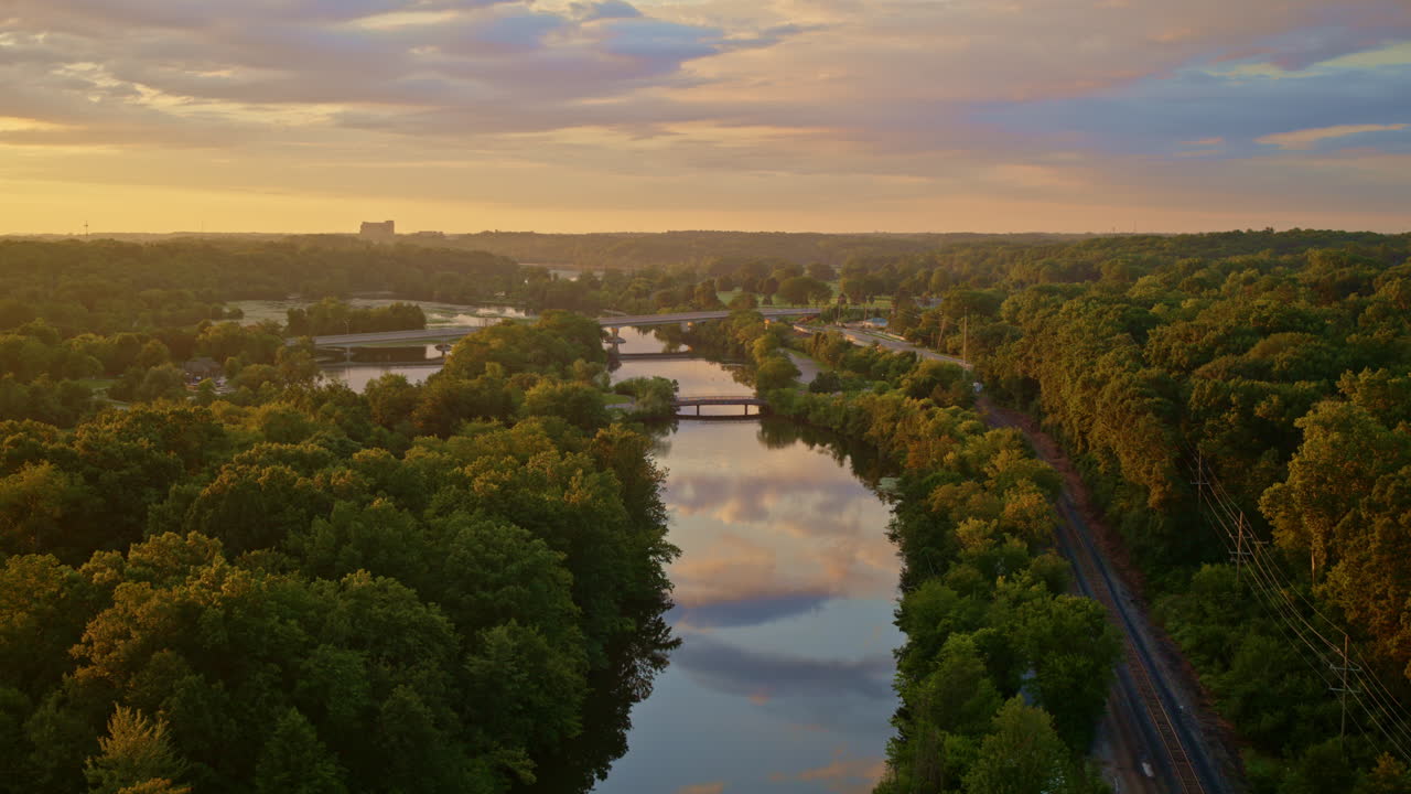 Aerial footage of a slow-moving drone over the Huron River in Ann Arbor, Michigan, during the summer season.