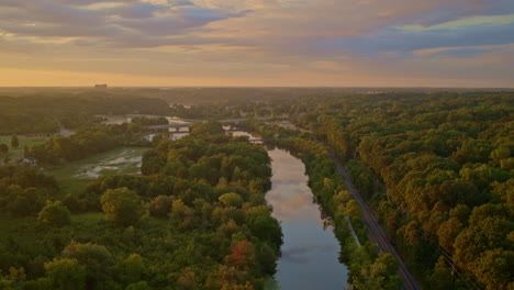 sunrise over a calm river in a lush forest