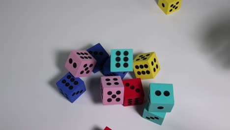 various dice scattered by hand on surface