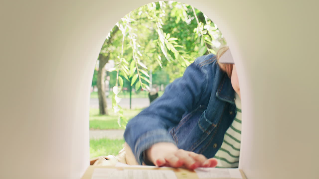 Young Boy Delivering Letters into Mailbox on Street
