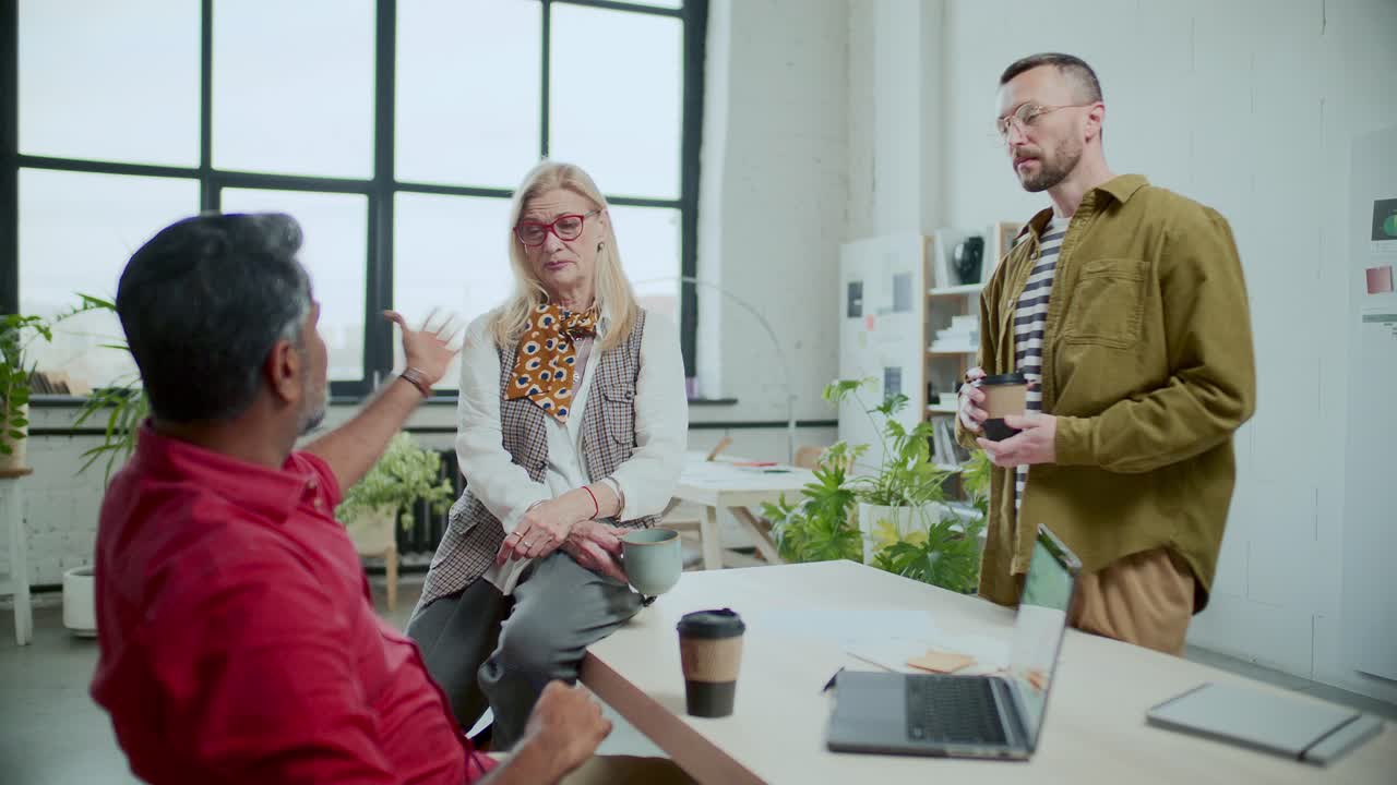 Diverse Business Team Chatting over Coffee during Office Break