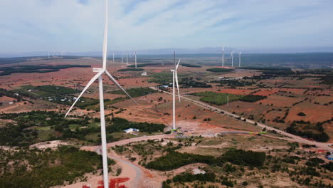 Aerial,-static-wind-turbines-in-Vietnam,-Binh-Thuan-province-energy-advancement