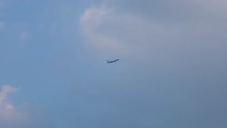 Nok-Air-climbing-and-gaining-altitude-as-it-passes-dark-gray-clouds-to-white-bright-clouds-after-takeoff-from-Don-Mueang-International-Airport,-Bangkok,-Thailand