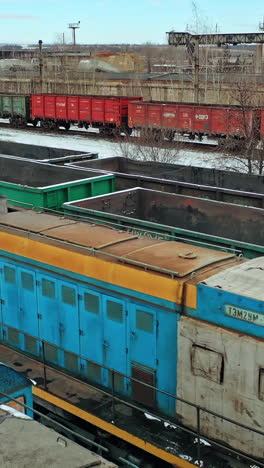 container freight train on station. station with freight trains and containers in aerial view. vertical video