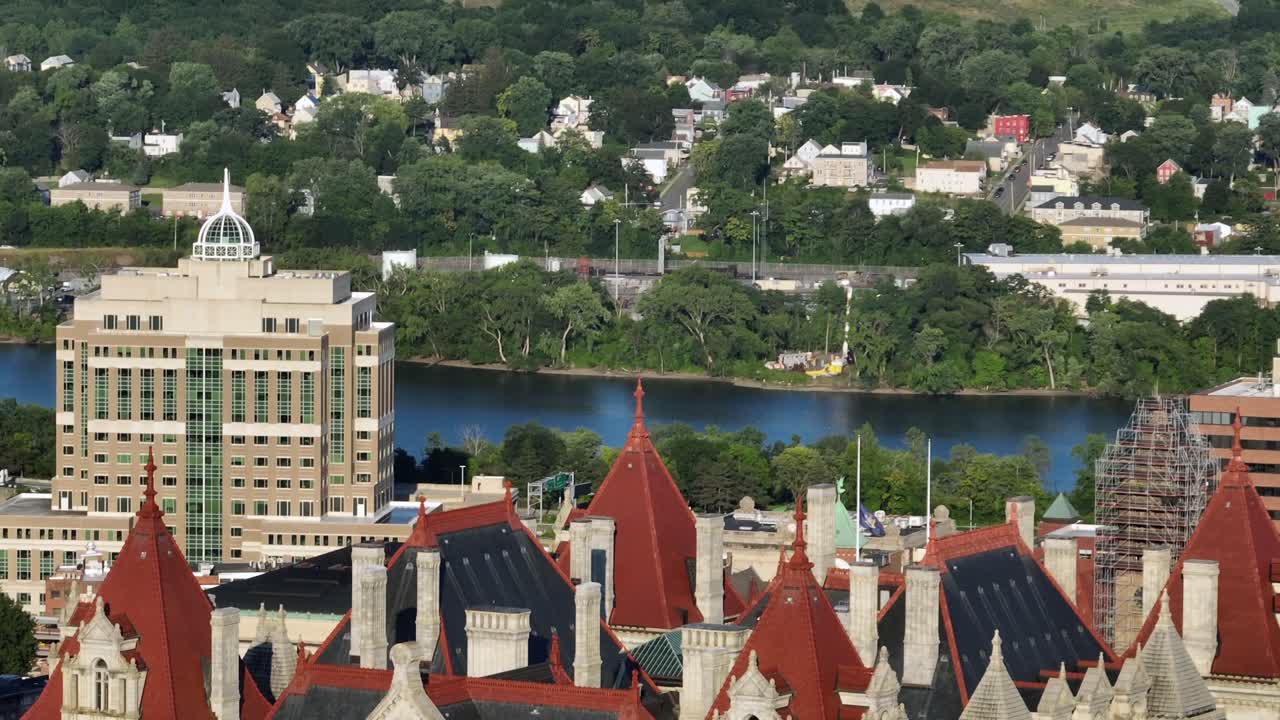 New York State capitol building in Albany and Department of Environmental Conservation in background. Aerial view. Sunny day in Albany, USA. Hudson River in distance. Sunset time. Zoom shot