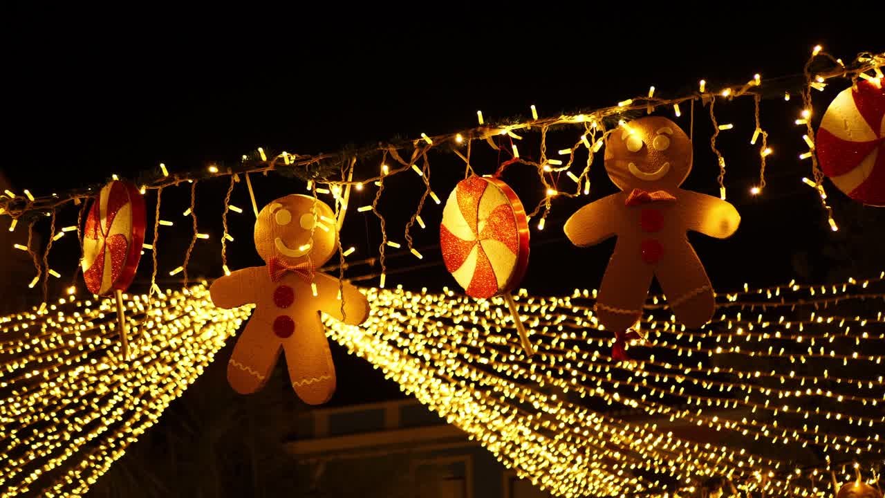 Static shot of Christmas decoration at night. Gingerbread men