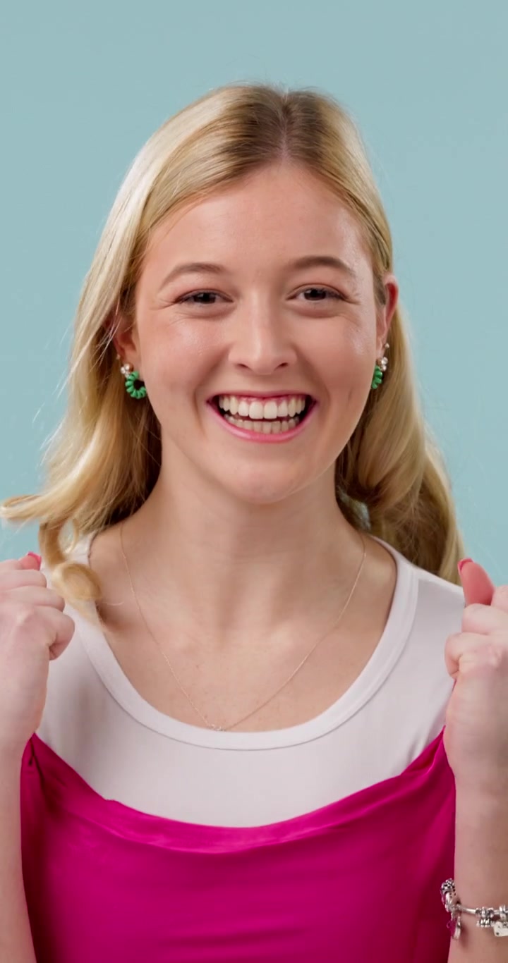 Excited Young Woman Celebrating Success Against a Blue Background
