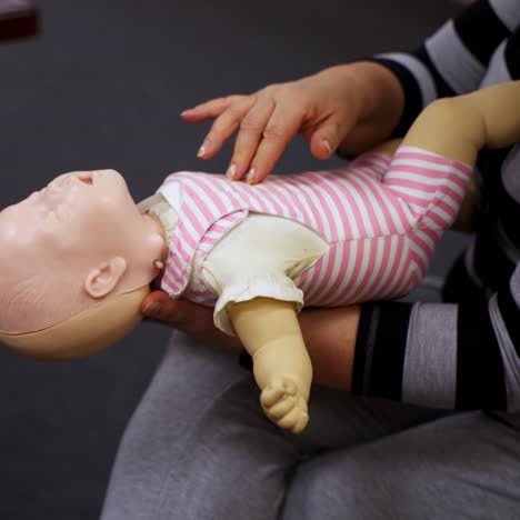 practicing reanimation of infants. medic shows tehnique with two fingers. appropriate methods of first medical help