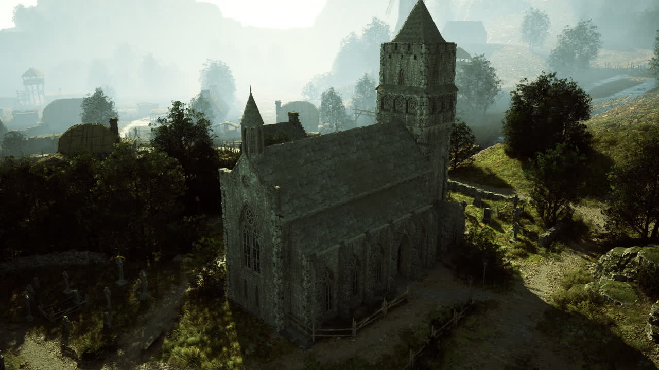 Old stone church in a lush green landscape during misty morning hours
