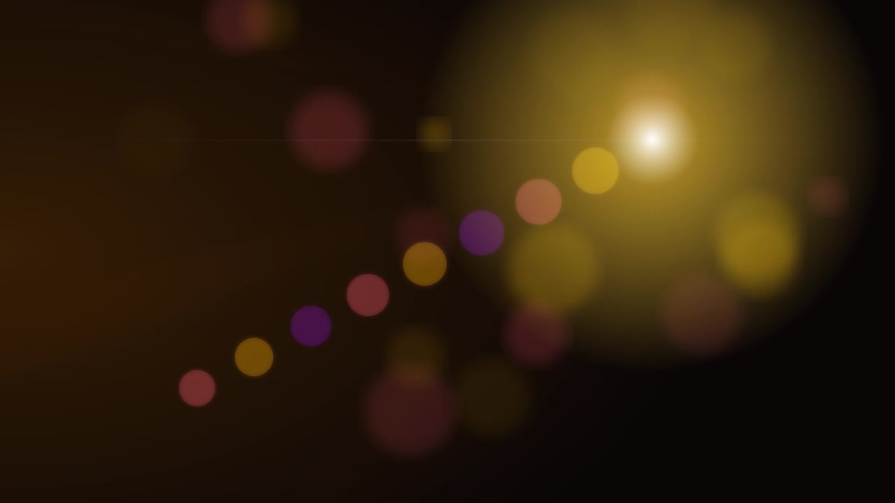 Abstract Golden Light Flares and Bokeh Particles on Dark Background