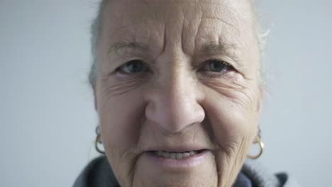 senior-old-woman-smile-in-front-of-camera-close-up-portrait-in-slow-motion