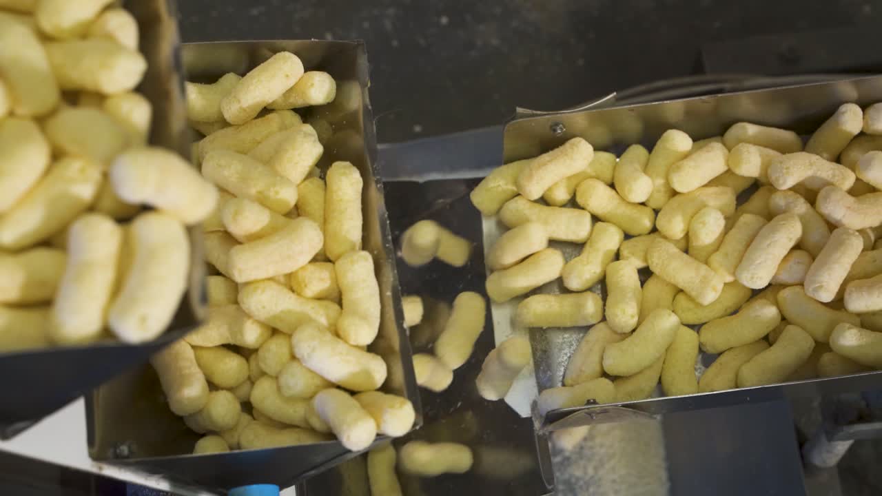 Automatic conveyor belt for packing corn sticks at a food industry plant. Move boxes up