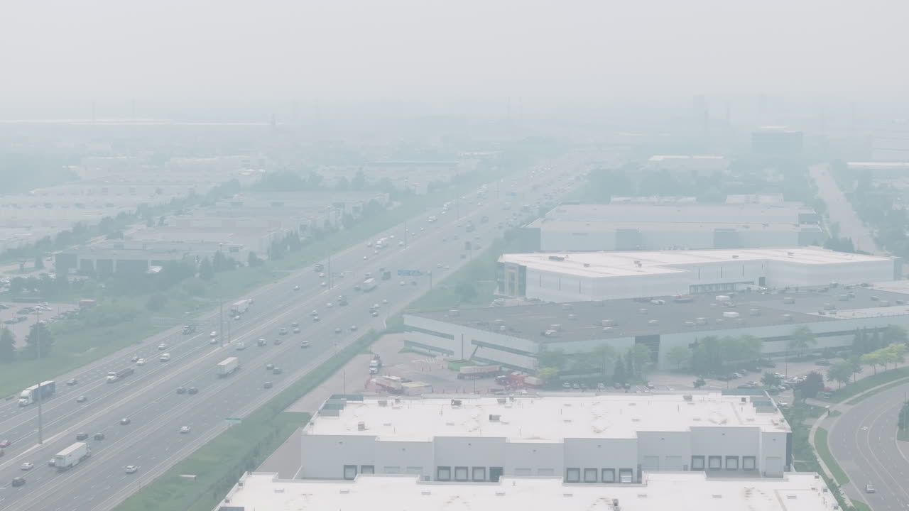 Smoky, hazy atmosphere over highway in Mississauga due to wildfire smoke