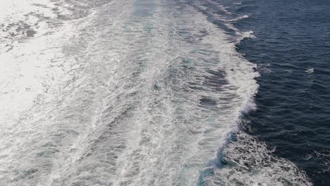 static wide slow-motion shot from cruise ship for the ocean with far mountain islands in background