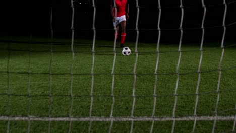 soccer player scoring a goal against open goal post 4k