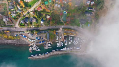 aerial birds eye view of boat marina beside lake moreno near san carlos de bariloche with clouds coming into view from left hand side