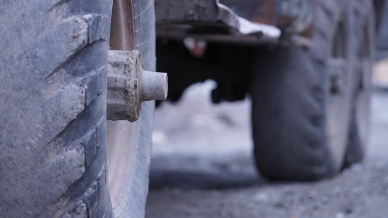 A tire of an old rusty truck