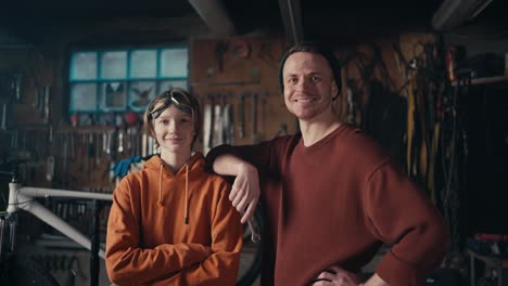 industrial mastery: a teen and mechanic's dedication. master and his young assistant posing against the backdrop of the workshop