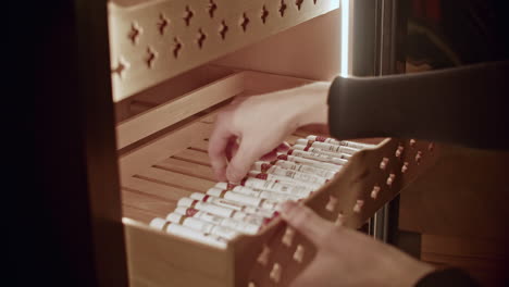 person opening cigar humidor drawer