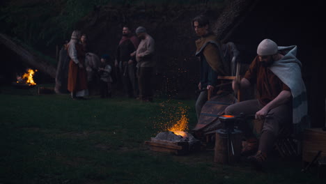 medieval campfire scene with blacksmith and gathering