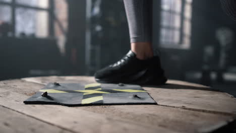 athlete legs jumping on wooden box. fit girl in sneakers using wooden box