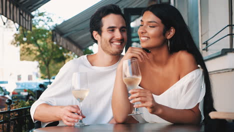 couple enjoying wine at an outdoor cafe
