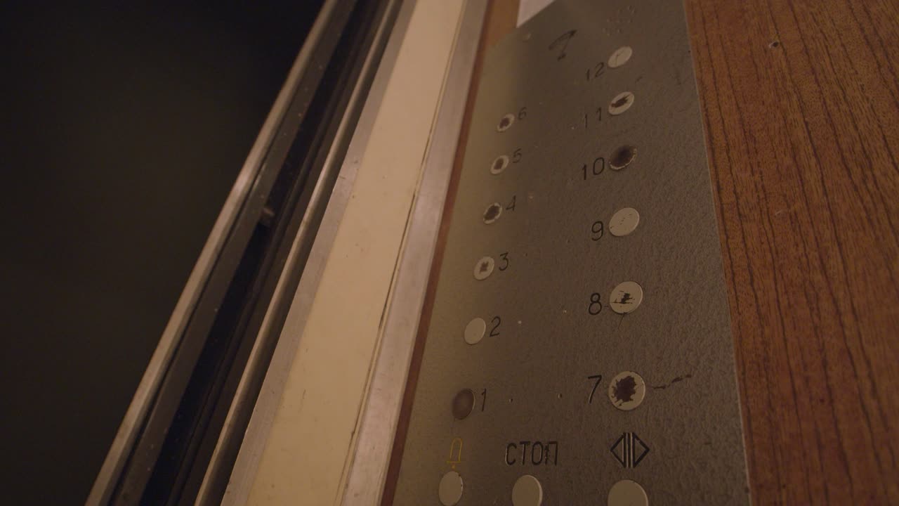 persona presionando un botón del ascensor