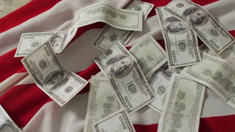 close up of american flag with banknotes and red and white stripes