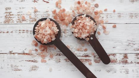 pink salt in wooden spoons