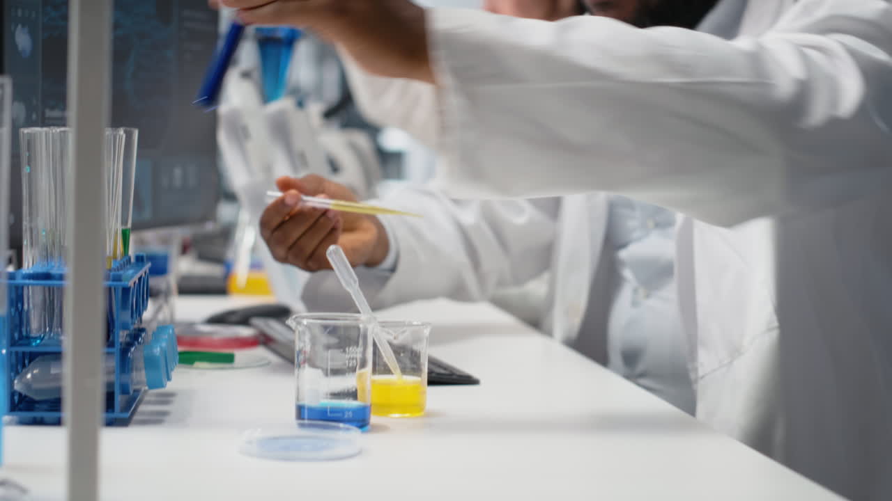 Vertical video Histology chemist conducting pipetting operation for chemical liquids