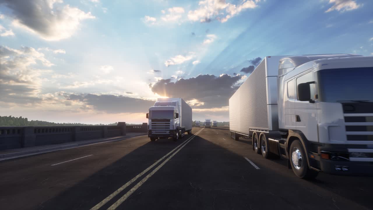 Caravana de camiones semirremolque blancos en la autopista al atardecer