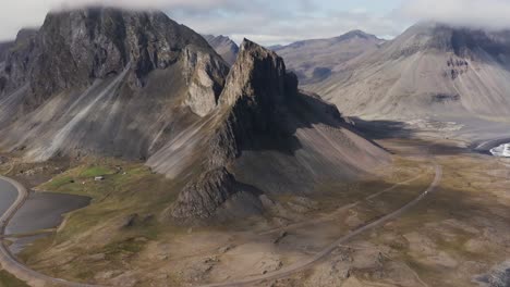 hvalnes volcanic mountains in breathtaking iceland landscape with sunlight