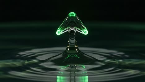 A Mesmerizing Green Water Droplet Formation Illuminated Against a Dark Background, Capturing the Intricate Beauty of Liquid Dynamics