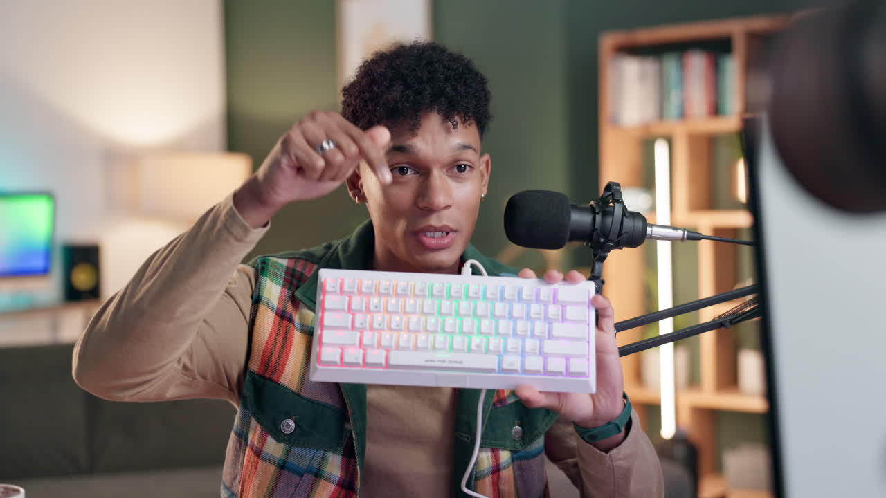Man holding a keyboard in front of a microphone