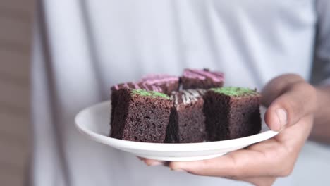 person holding a plate of brownies