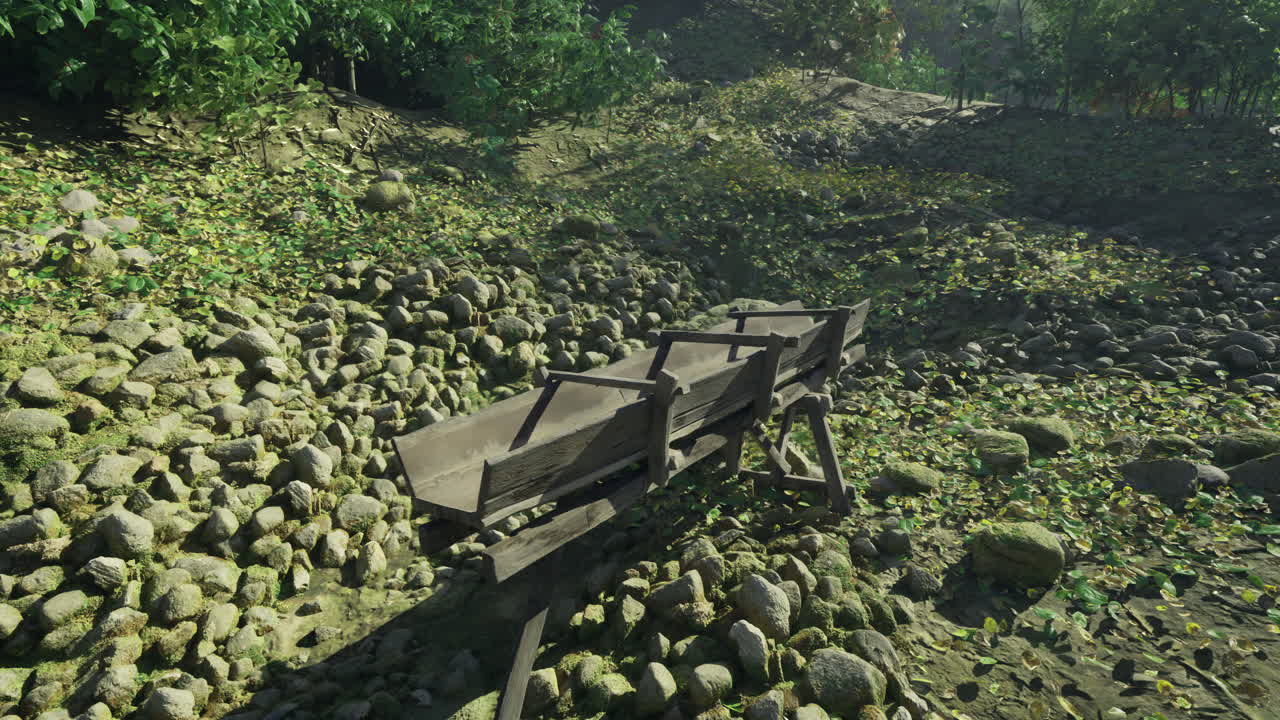 Old cart rests among stones in a serene natural setting during daytime