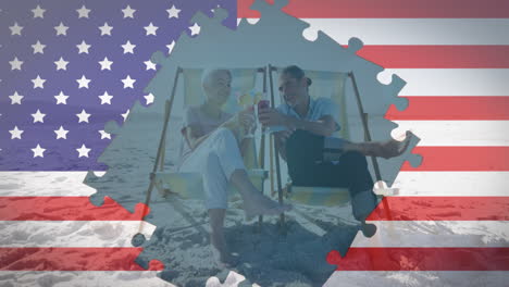 animation of american flag jigsaw puzzles revealing senior couple with drinks in deckchairs on beach
