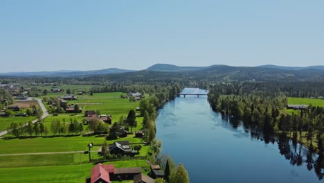 countryside with idyllic village by the river vasterdalalven in appelbo, dalarna county, sweden