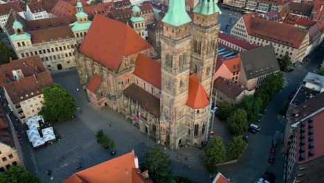 4k aerial drone video of gothic sebalduskirche church with twin spiers in nurnberg, germany - tilt up