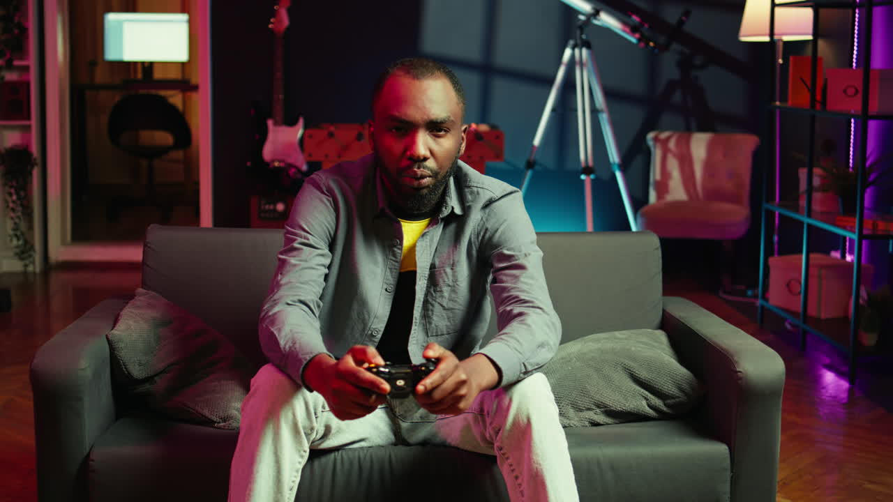 Player in RGB lit home gaming with joystick