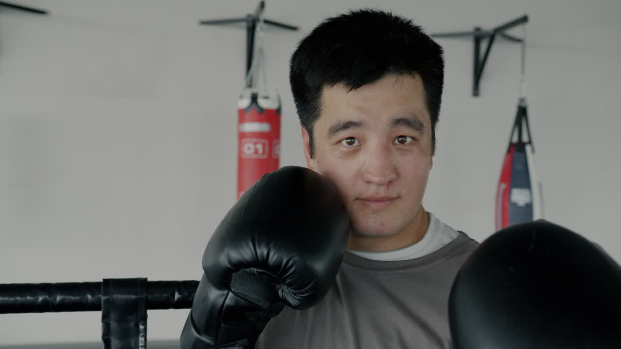 Man in Boxing Gloves in a Gym