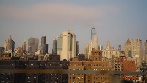 slow motion pov: housing area district in manhattan with modern skyline during golden hour
