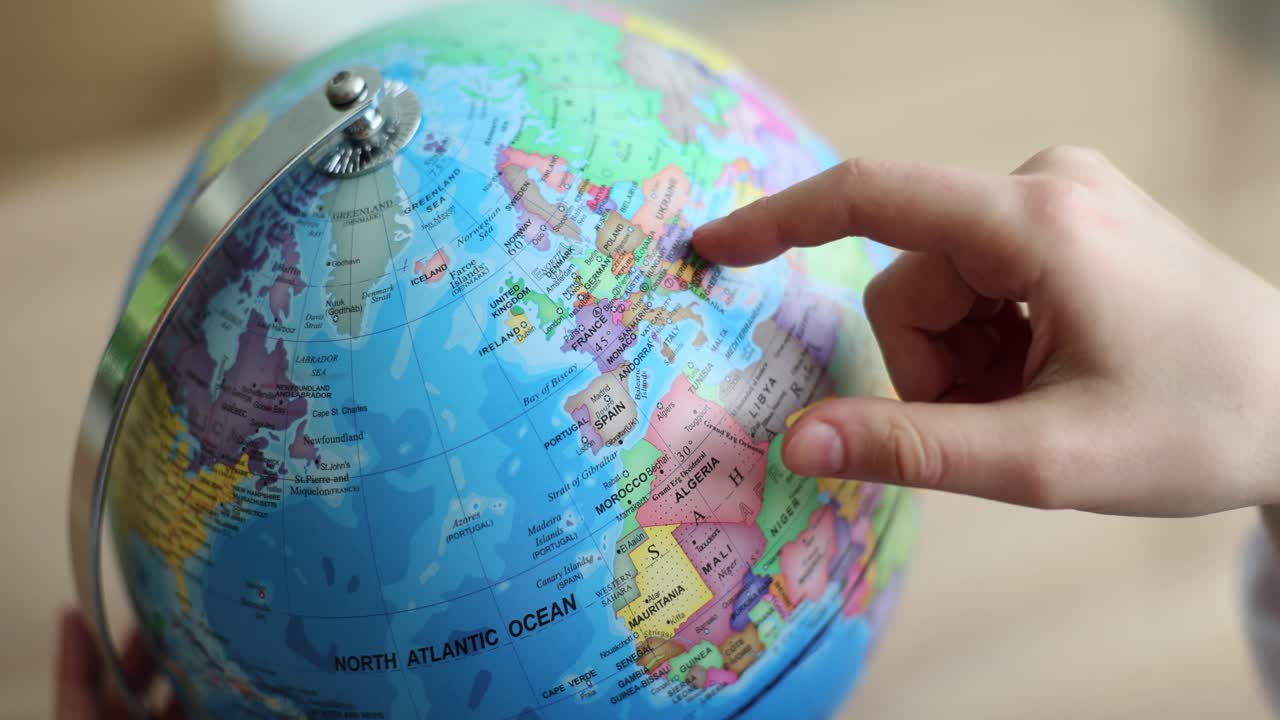 Globe with hand pointing to Europe