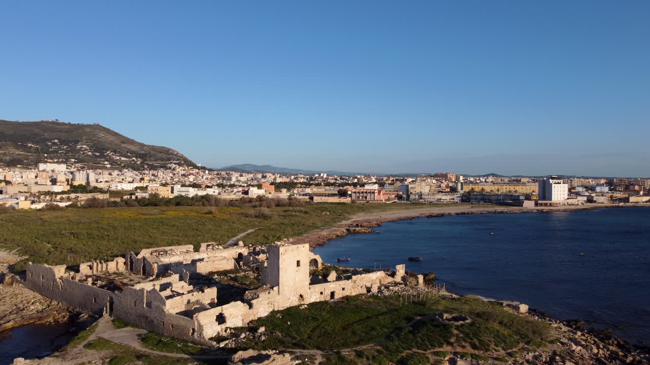 Aerial flying backwards from Tuna fishery of San Giuliano, Trapani, Sicily, Italy
