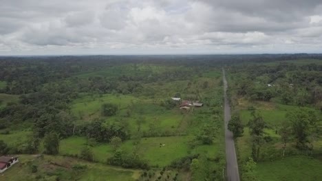 roadway through majestic green landscape of ecuador, aerial drone shot