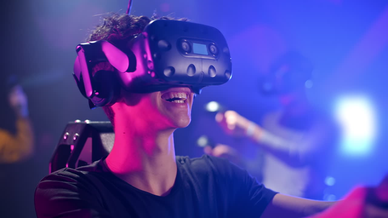 A joyful, interested boy is playing on VR treadmill with helmet, controllers and a backpack. Other people playing nearby